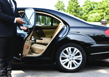 Chauffeured executive sedan in front of office